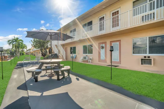 a view of a patio with table and chairs and potted plants