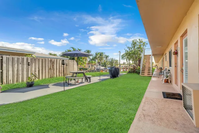 a view of a backyard with sitting area