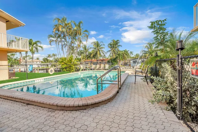 a view of a swimming pool with a outdoor seating