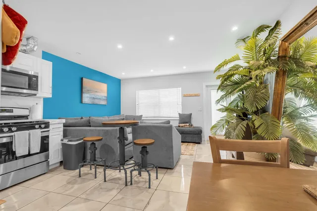a view of a dining room with furniture and a potted plant