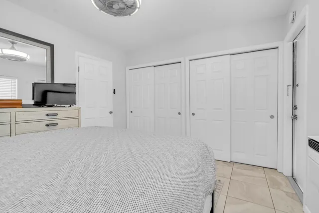 a room with white cabinets and dust couch