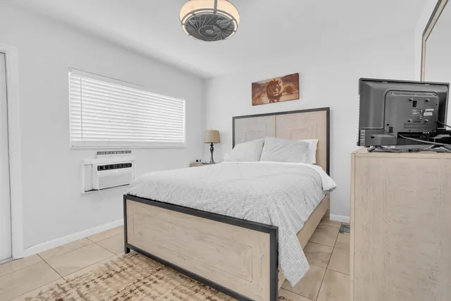 a bedroom with a bed and a television