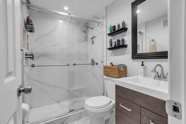 a bathroom with a sink toilet and shower