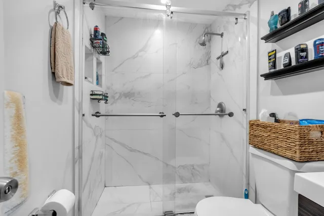 a bathroom with a shower toilet and sink