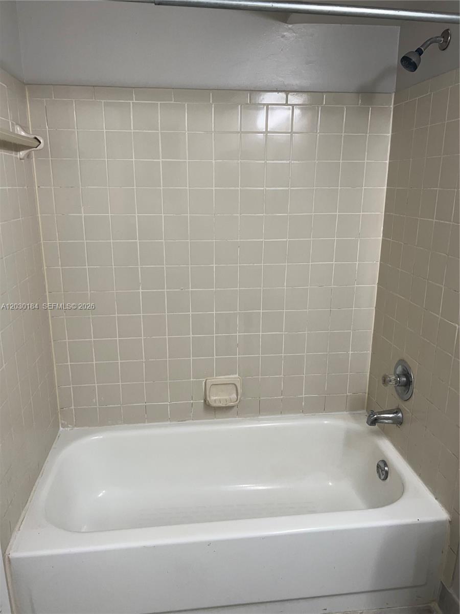 951 Lyons Road, Unit 6104 Coconut Creek, FL 33063 - Photo 5 of 18 a bathroom with a bathtub
