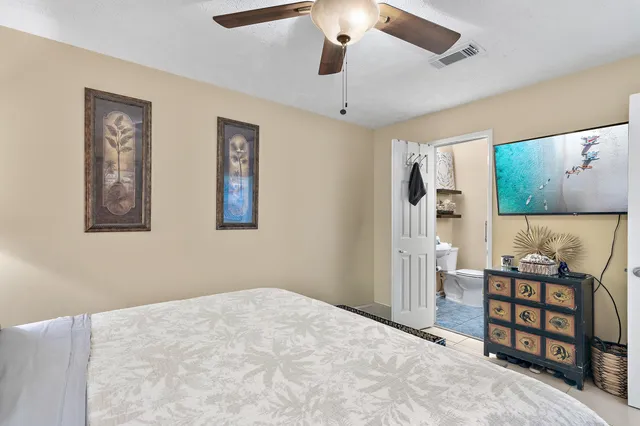 a bedroom with a bed and a painting on the wall