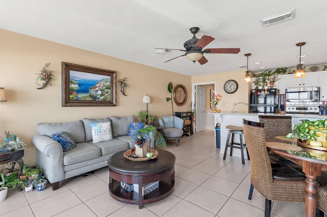 a living room with furniture and a clock