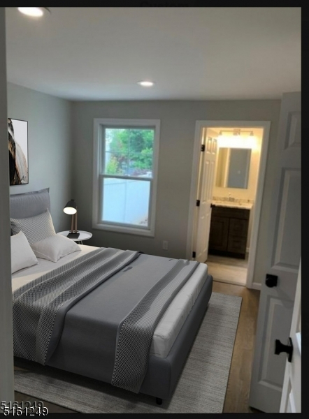 518 Trinity Place, Unit 2 Westfield, NJ 07090 - Photo 2 of 11 a bedroom with a bed and a window