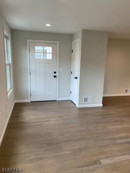 518 Trinity Place, Unit 2 Westfield, NJ 07090 - Photo 3 of 11 an empty room with wooden floor and windows