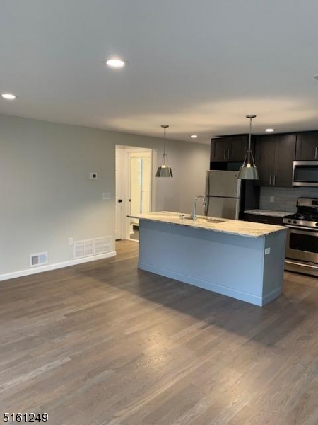 518 Trinity Place, Unit 2 Westfield, NJ 07090 - Photo 4 of 11 a large kitchen with stainless steel appliances a large counter top a stove and a refrigerator