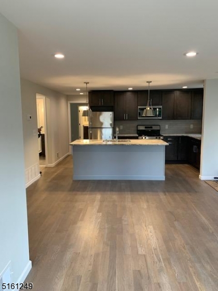 518 Trinity Place, Unit 2 Westfield, NJ 07090 - Photo 5 of 11 a view of kitchen with kitchen island microwave and stove