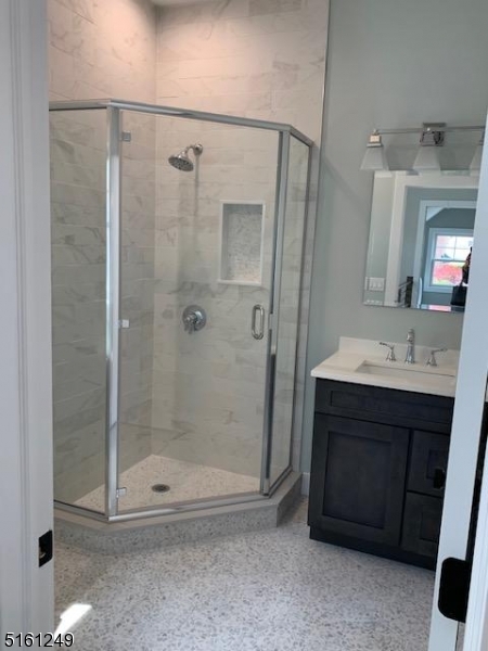 518 Trinity Place, Unit 2 Westfield, NJ 07090 - Photo 7 of 11 a bathroom with a shower a sink and a mirror