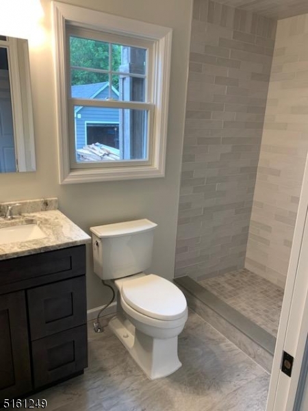 518 Trinity Place, Unit 2 Westfield, NJ 07090 - Photo 8 of 11 a bathroom with a toilet a sink and a mirror