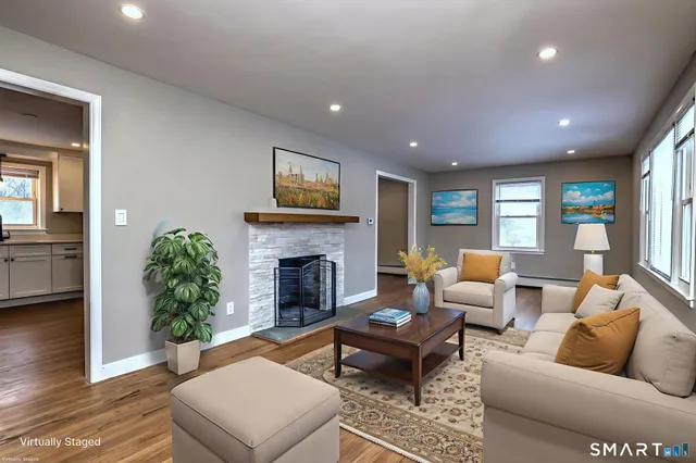 a living room with furniture and a fireplace