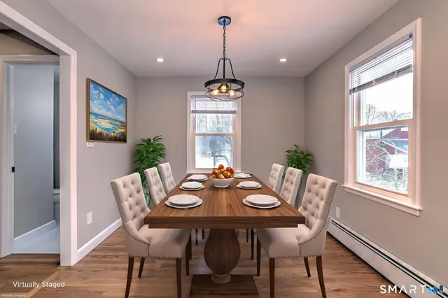 a view of a dining room with furniture window and wooden floor