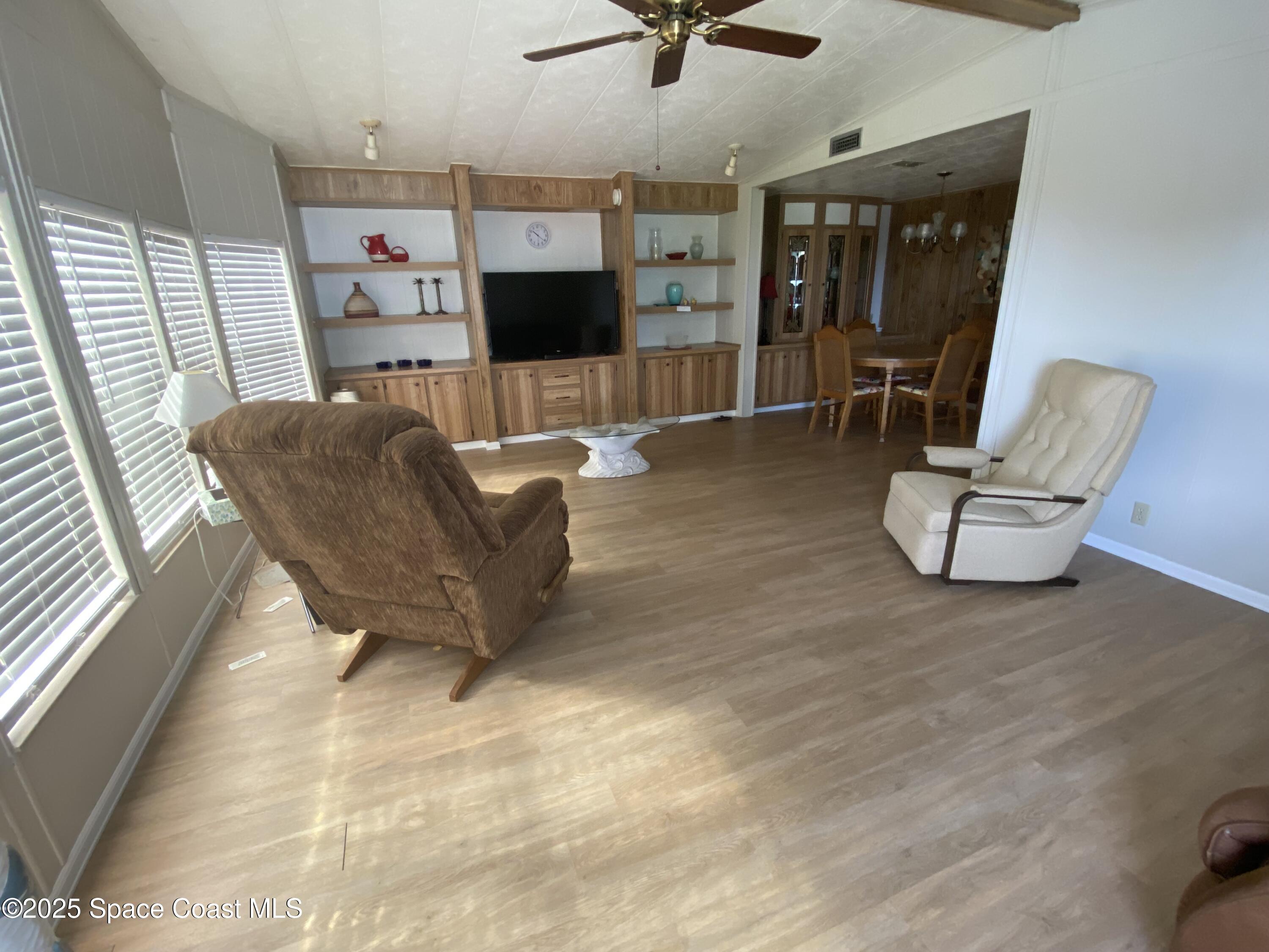 1906 Mango Street Northeast Palm Bay, FL 32905 - Photo 12 of 42 a living room with furniture and a flat screen tv