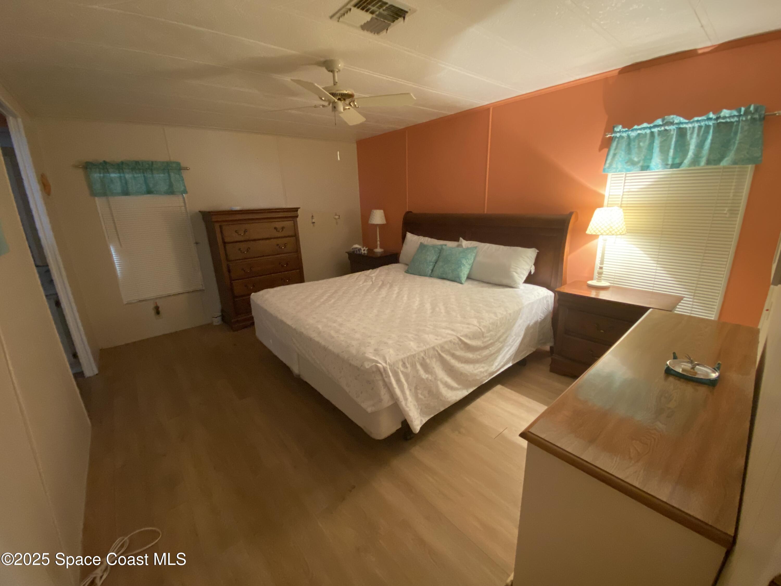 1906 Mango Street Northeast Palm Bay, FL 32905 - Photo 15 of 42 a bedroom with a bed and a table