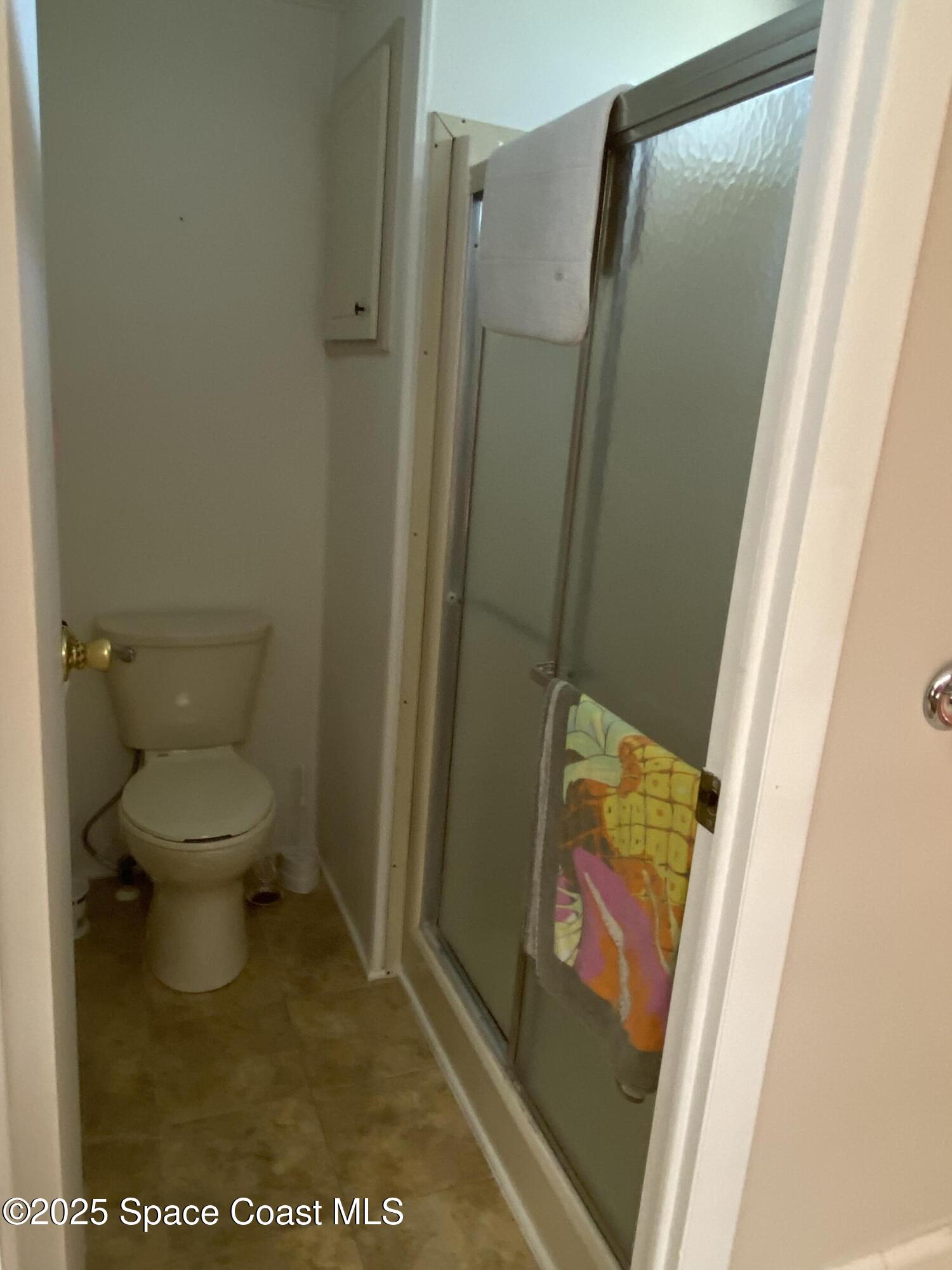 1906 Mango Street Northeast Palm Bay, FL 32905 - Photo 17 of 42 a bathroom with a toilet and a shower