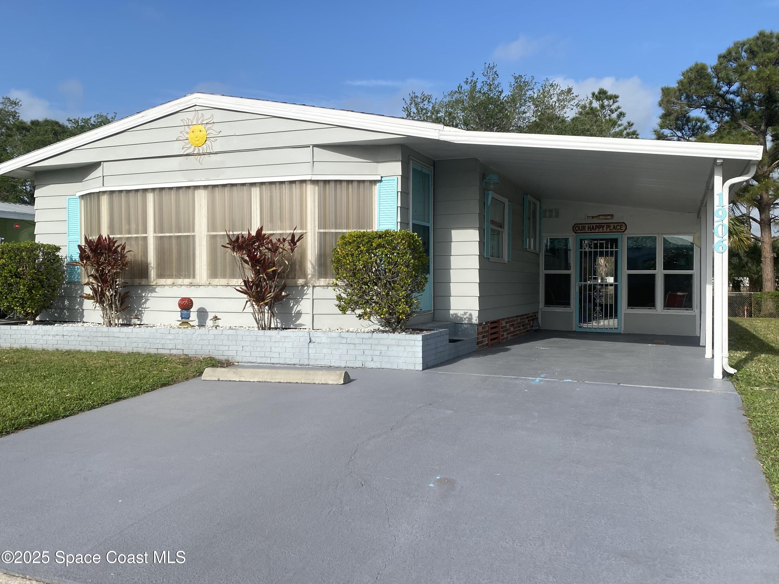 1906 Mango Street Northeast Palm Bay, FL 32905 - Photo 2 of 42 front view of a house with a yard