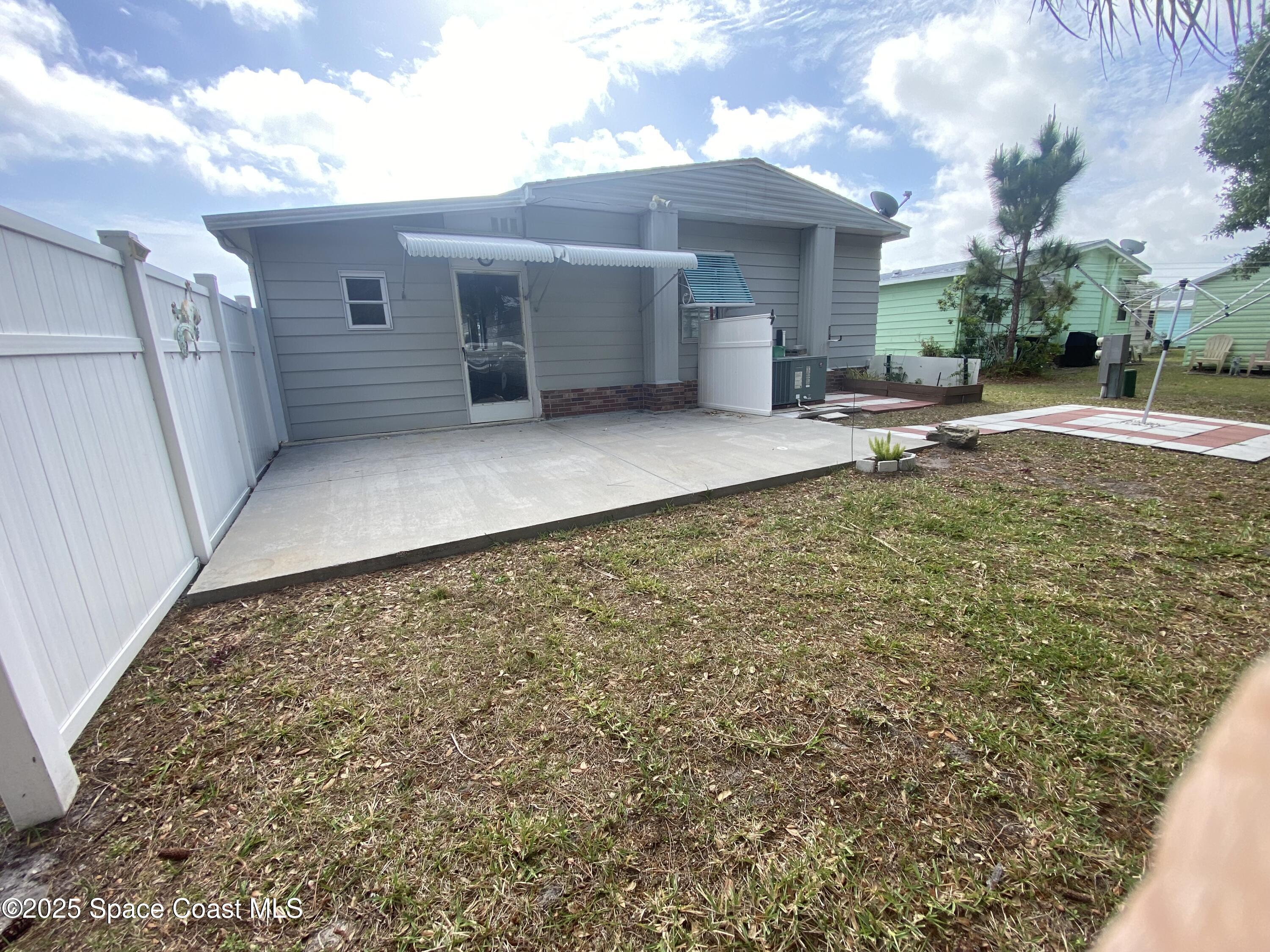 1906 Mango Street Northeast Palm Bay, FL 32905 - Photo 23 of 42 a view of a yard with a house