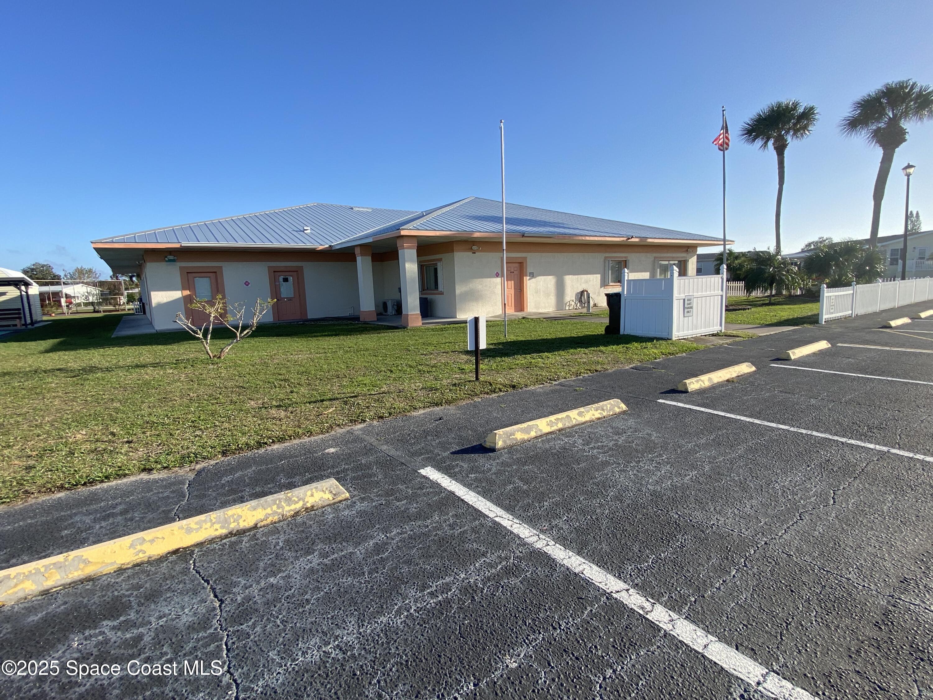 1906 Mango Street Northeast Palm Bay, FL 32905 - Photo 27 of 42 a front view of a house with a garden and yard