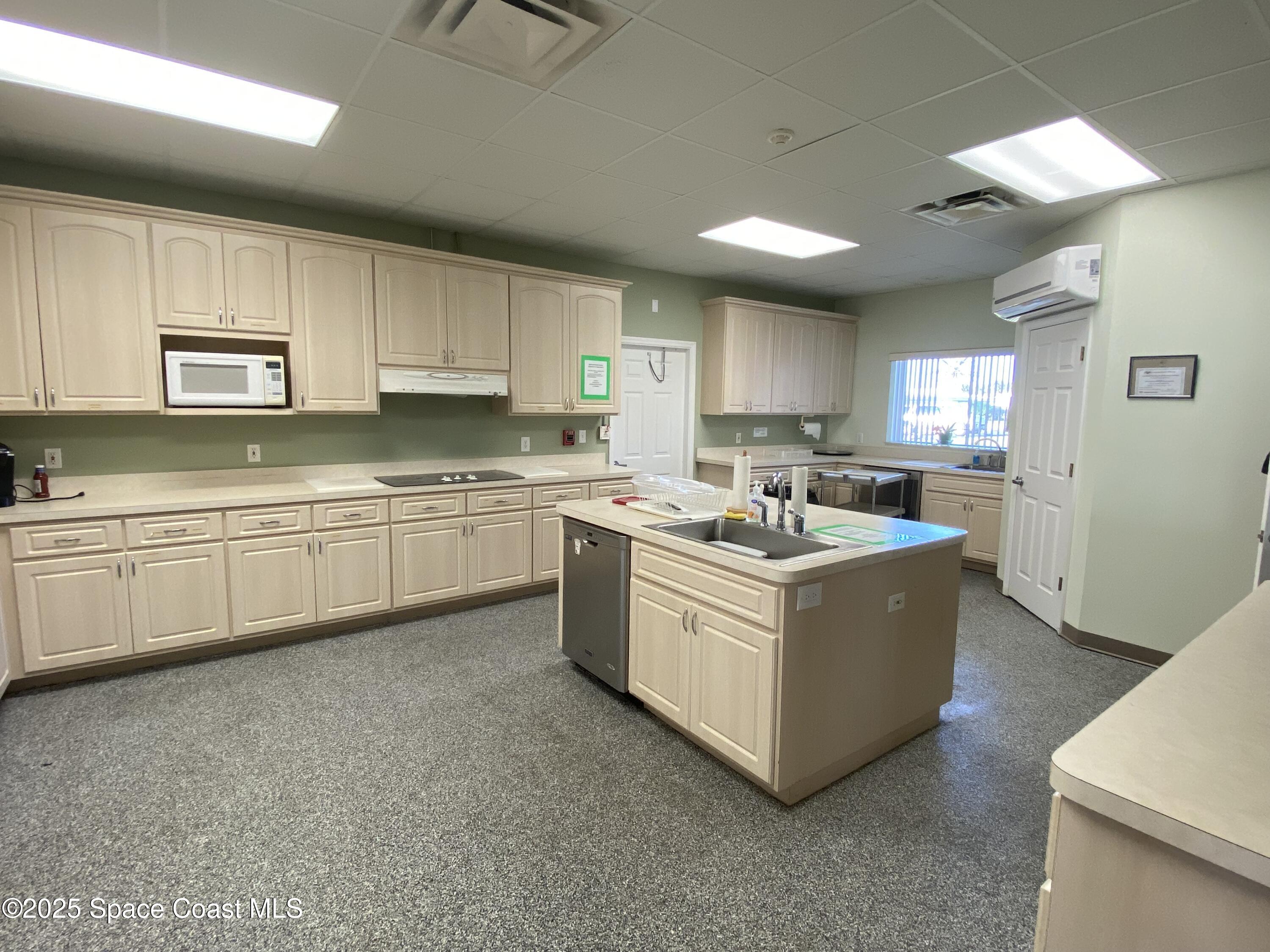 1906 Mango Street Northeast Palm Bay, FL 32905 - Photo 29 of 42 a kitchen with stainless steel appliances granite countertop a sink and a white cabinets