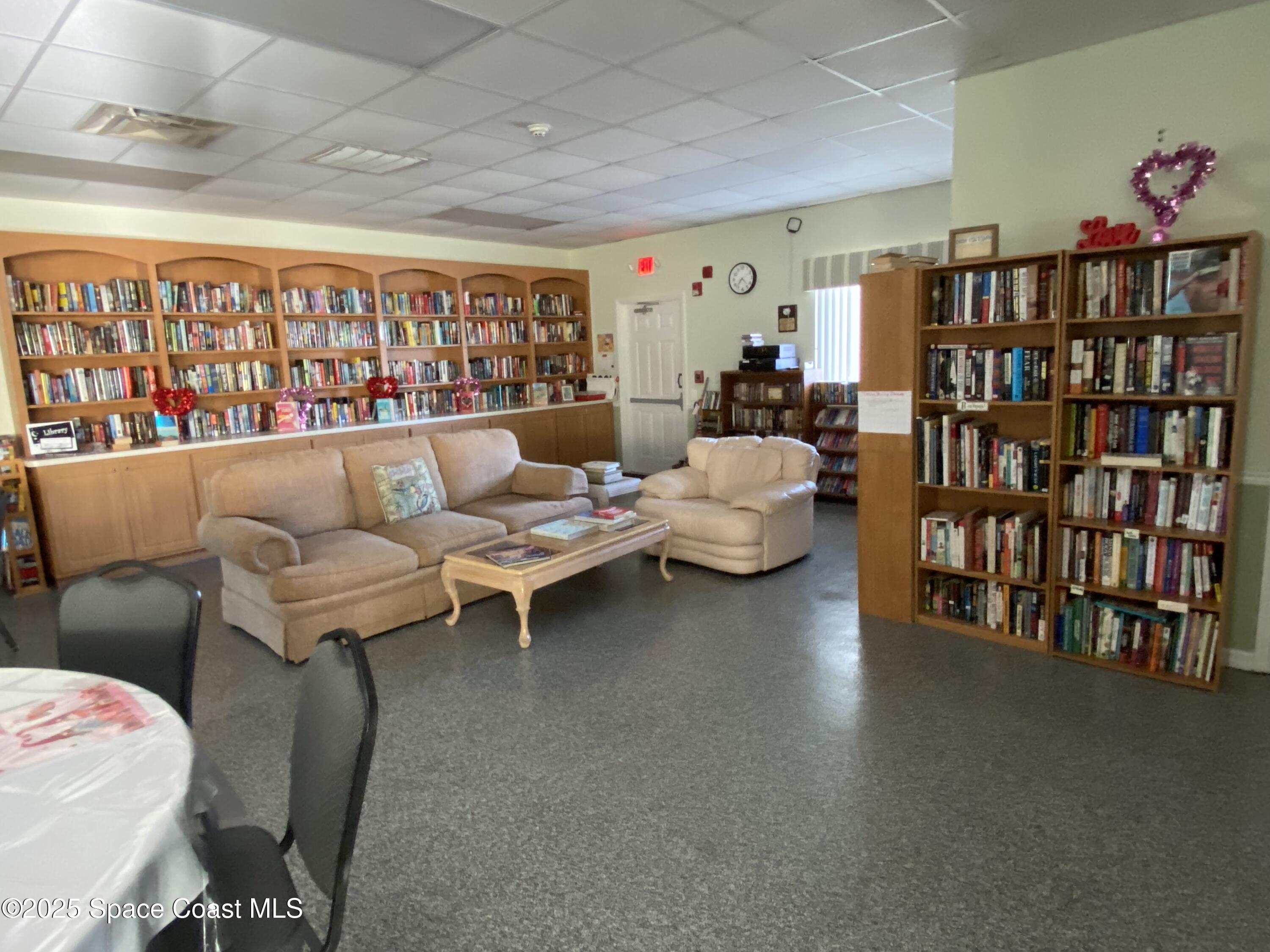 1906 Mango Street Northeast Palm Bay, FL 32905 - Photo 33 of 42 a living room with lots of furniture and a book shelf