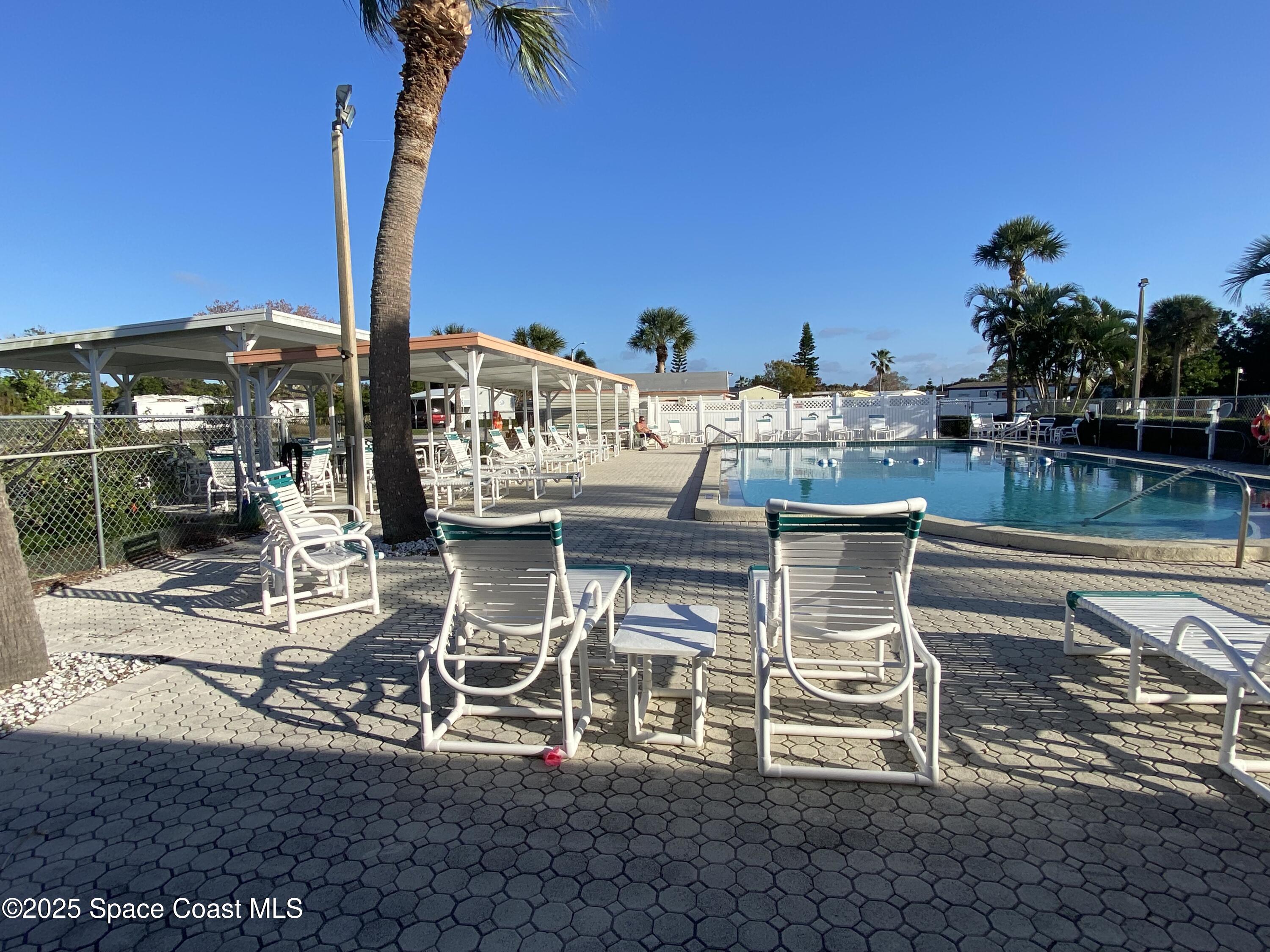 1906 Mango Street Northeast Palm Bay, FL 32905 - Photo 37 of 42 a view of a terrace with furniture and a table and chairs