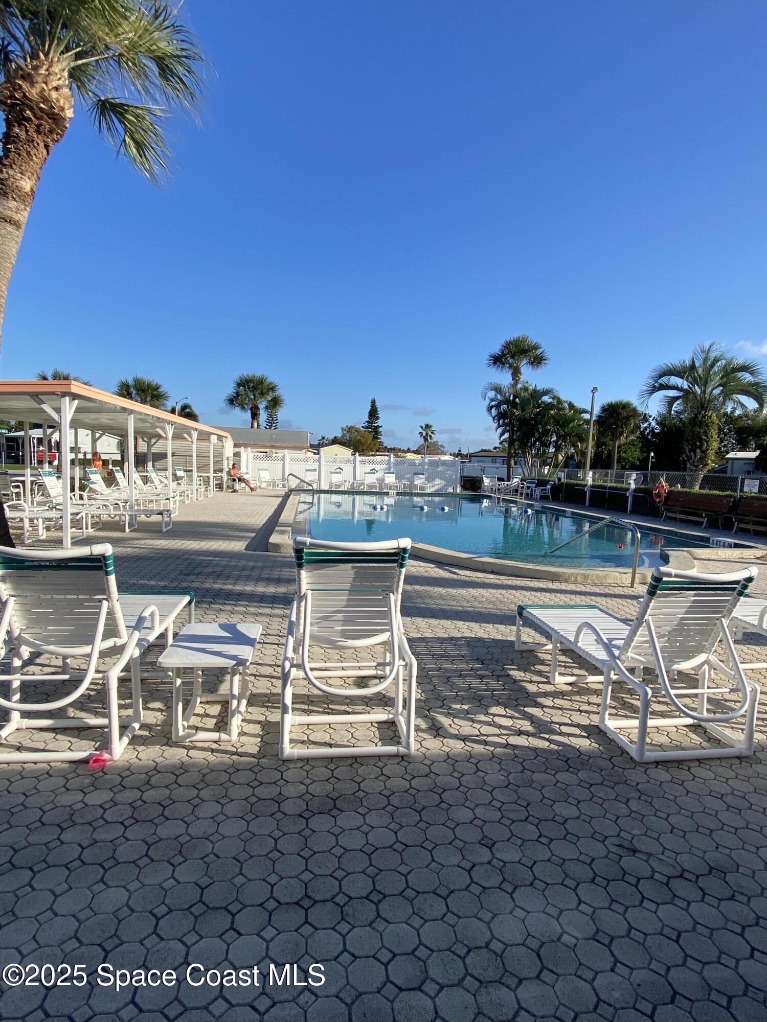 1906 Mango Street Northeast Palm Bay, FL 32905 - Photo 39 of 42 a view of a swimming pool with outdoor seating