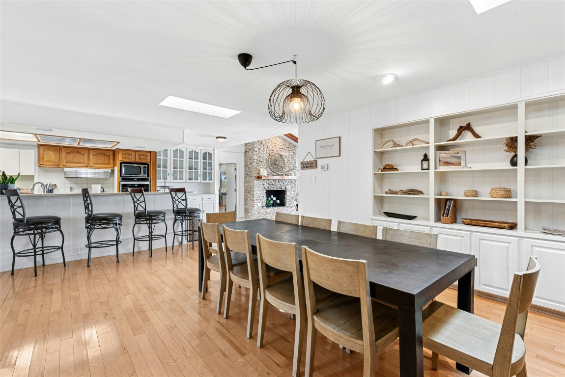 110 Longhorn Lane Dripping Springs, TX 78620 - Photo 11 of 40 a view of a dining room with furniture and wooden floor