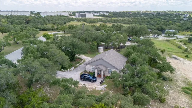 an aerial view of a house with yard and outdoor seating