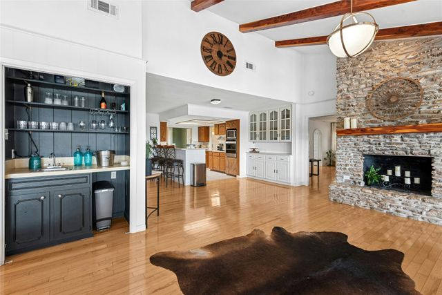 a living room with fireplace furniture and a wooden floor