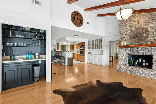 a living room with fireplace furniture and a wooden floor