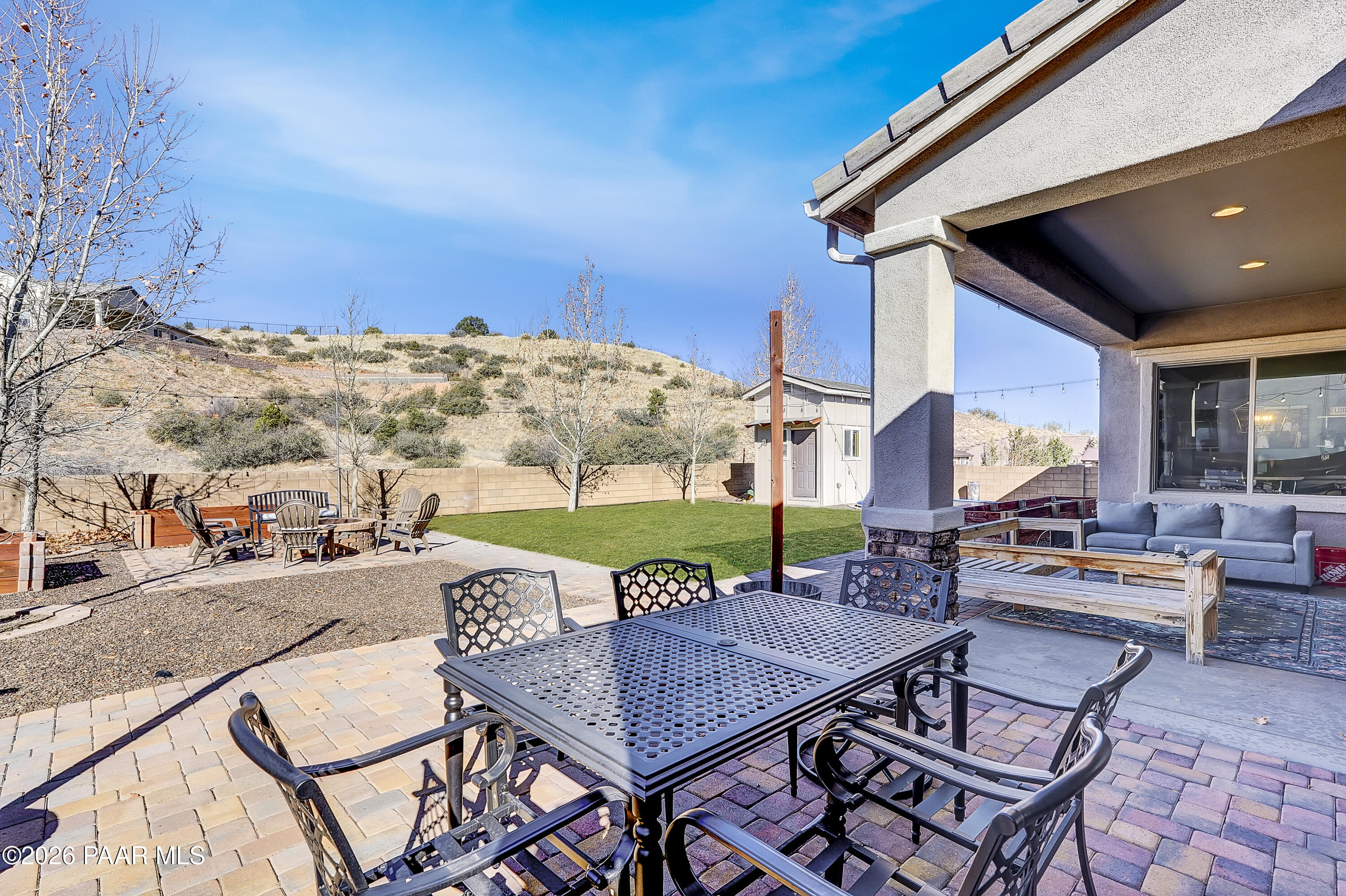 2032 Summer View Drive Prescott, AZ 86301 - Photo 12 of 17 a view of a patio with a dining table and chairs with a barbeque