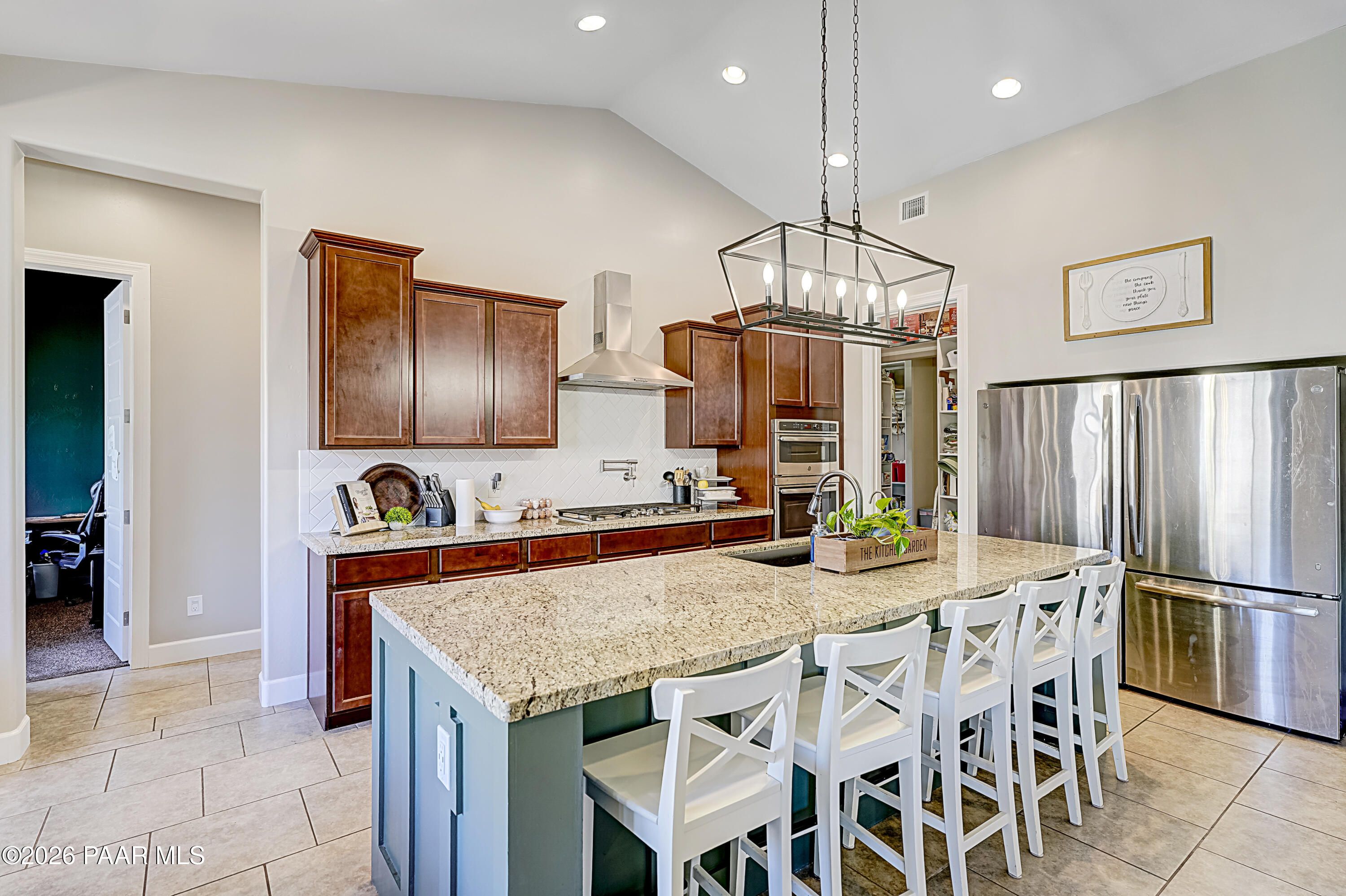 2032 Summer View Drive Prescott, AZ 86301 - Photo 3 of 17 a kitchen with stainless steel appliances granite countertop a kitchen island a table and chairs in it