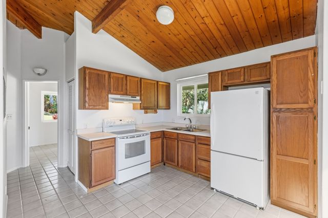 a white refrigerator freezer sitting inside of a kitchen