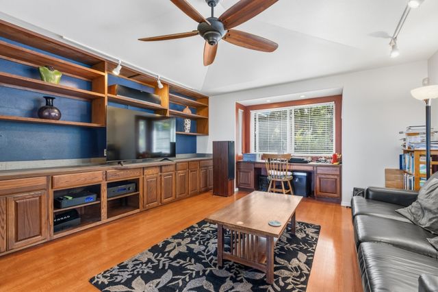 a living room with furniture a rug and a window