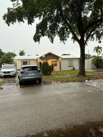 a view of a car parked in front of a house