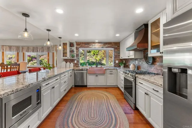 an aerial view of a house with outdoor space and a lake view