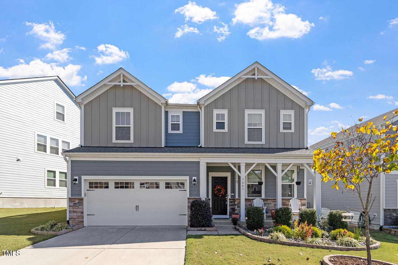 1443 Tinos Overlook Way Apex, NC 27502 - Photo 1 of 31 a front view of a house with a yard and a garage