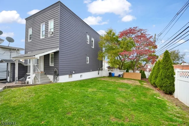 a view of a house with a patio and a yard