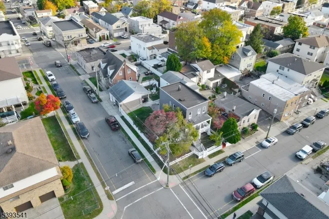 an aerial view of residential house with parking