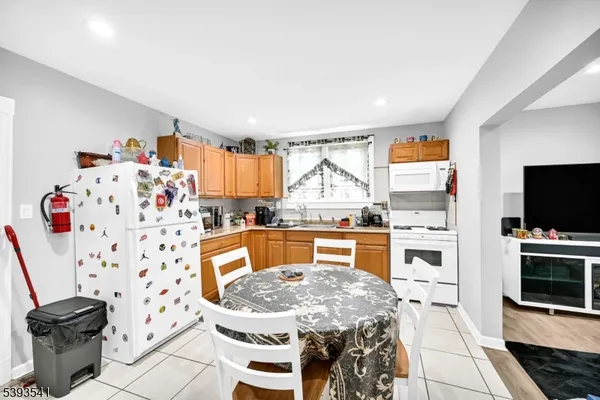 a kitchen with a table chairs stove and cabinets