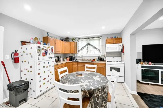 a kitchen with a table chairs stove and cabinets