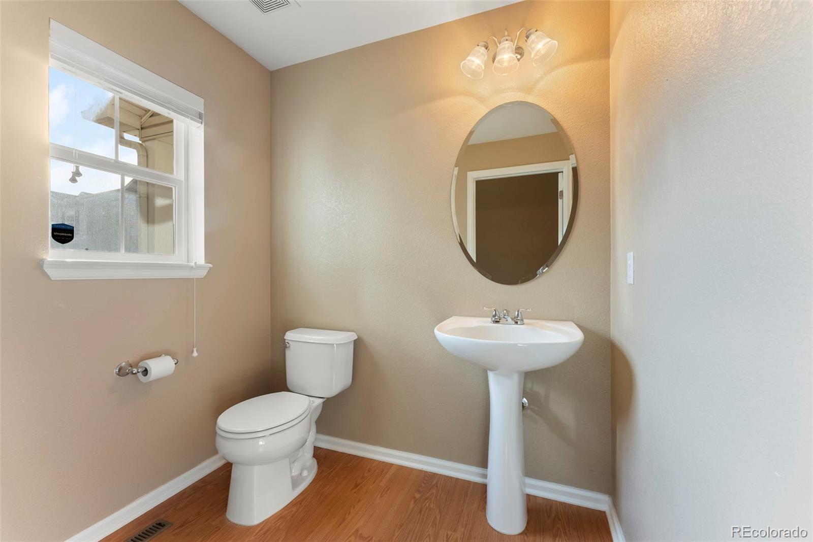 2020 Squawbush Ridge Grove Colorado Springs, CO 80910 - Photo 13 of 29 a bathroom with a toilet sink and mirror