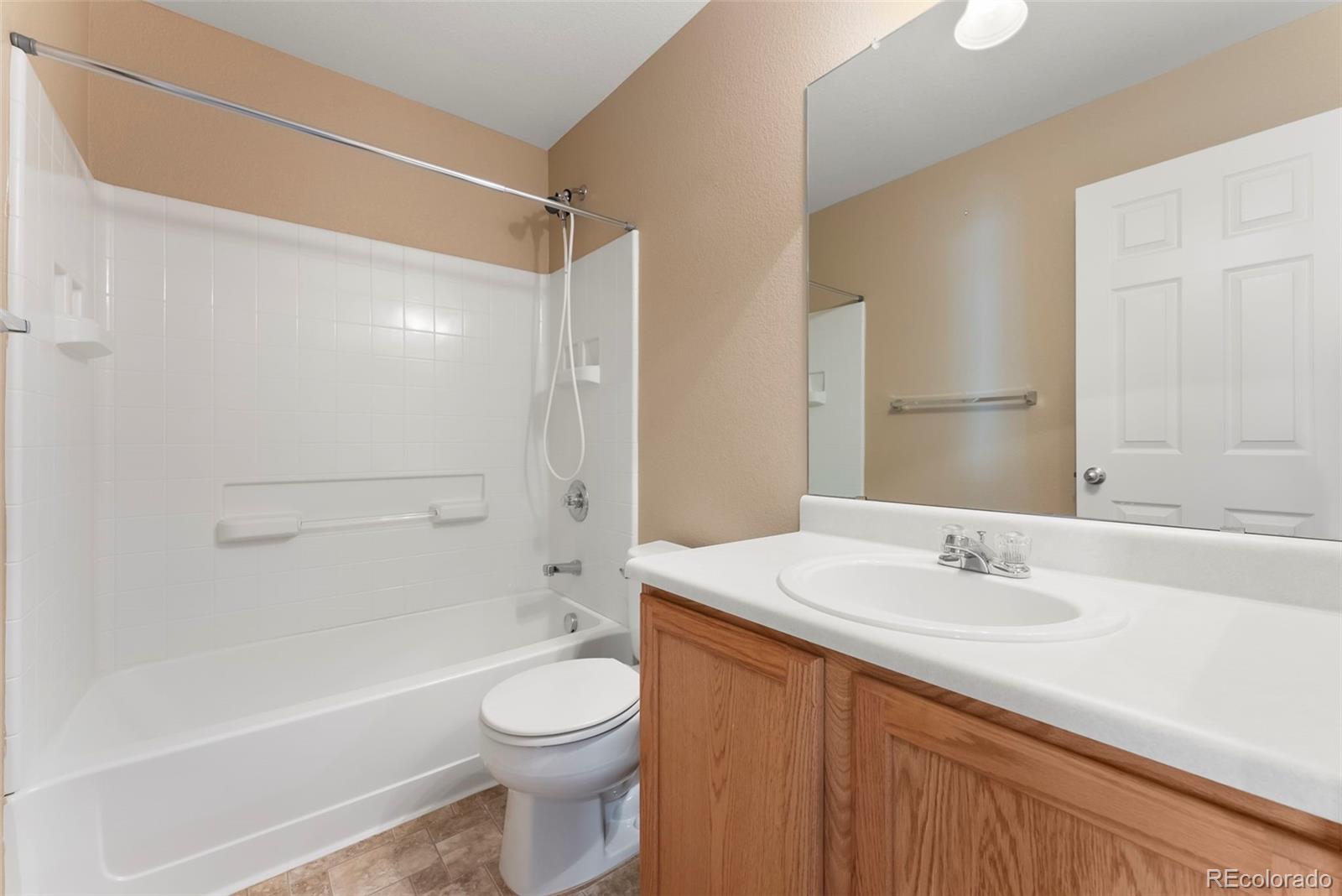 2020 Squawbush Ridge Grove Colorado Springs, CO 80910 - Photo 18 of 29 a bathroom with a sink a toilet and shower