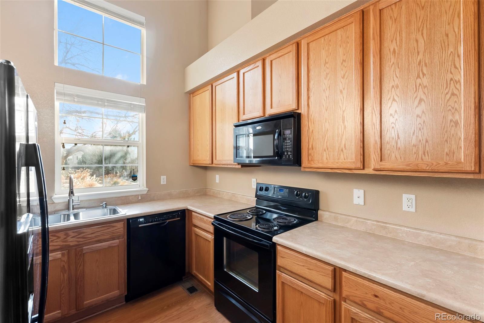 2020 Squawbush Ridge Grove Colorado Springs, CO 80910 - Photo 7 of 29 a kitchen with granite countertop a sink cabinets stainless steel appliances and a window
