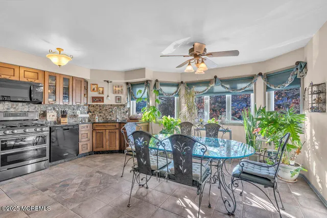 a view of a dining room with furniture and a kitchen