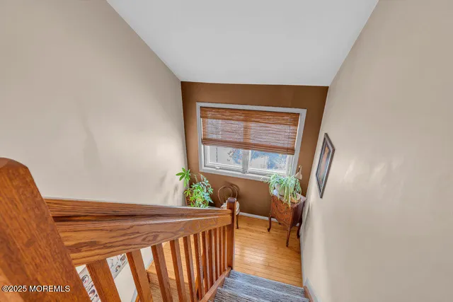 a view of a hallway to a livingroom with furniture