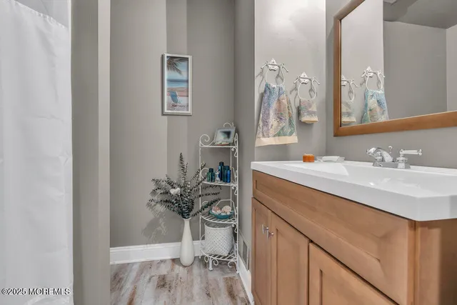 a bathroom with a sink vanity granite and a mirror